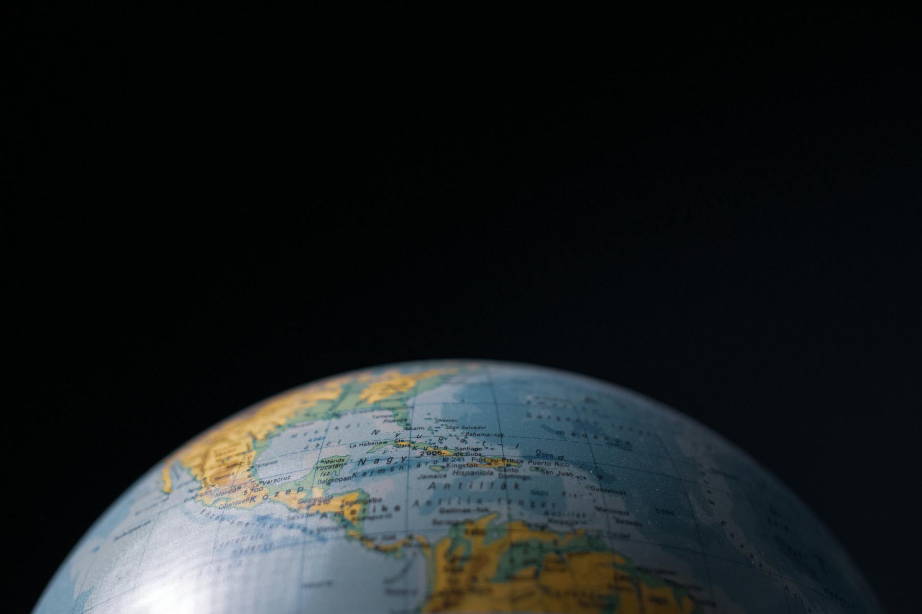 Focused image of a globe highlighting Cuba and Central America with a dark background.
