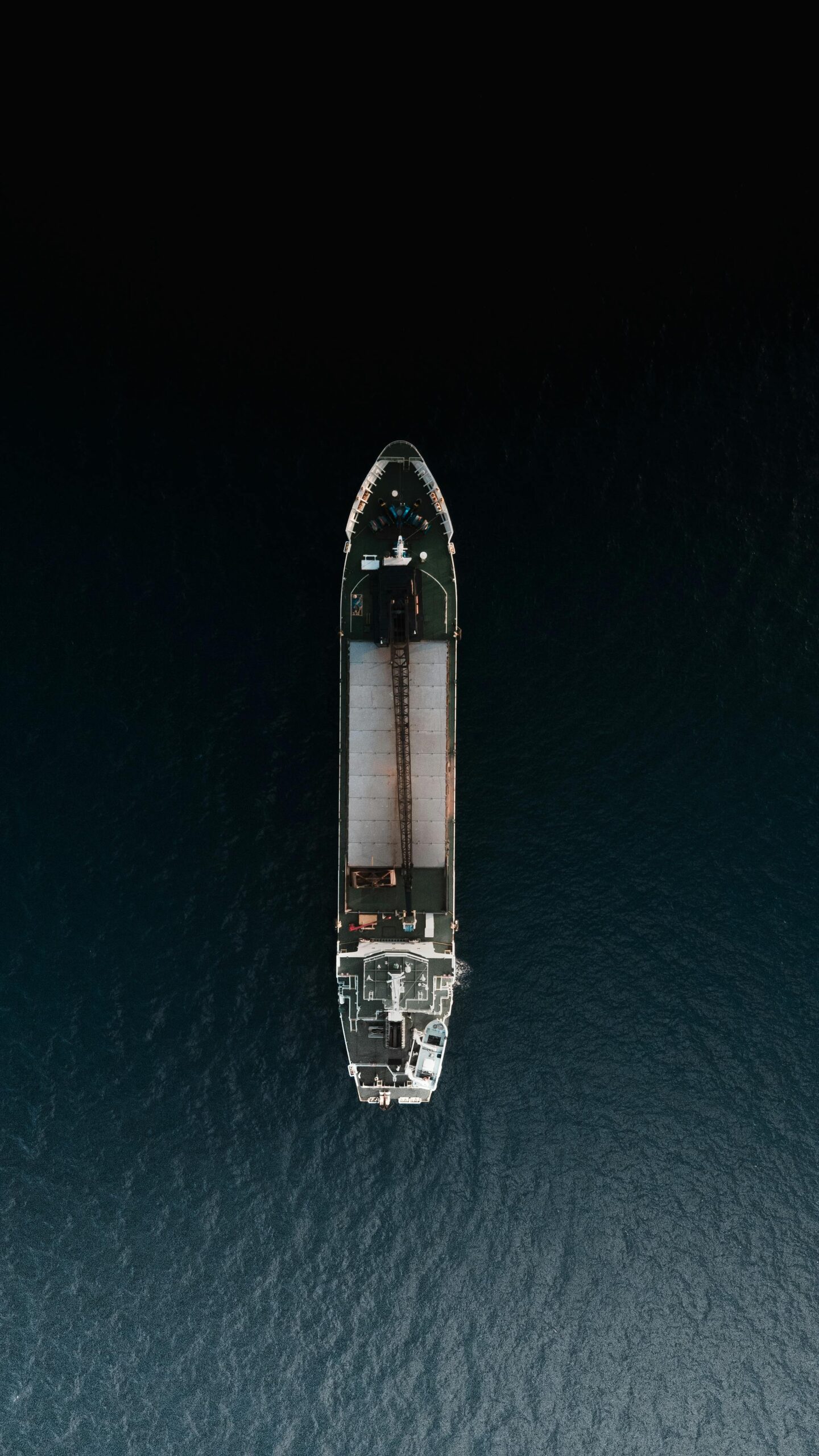 Top-down view of a cargo ship navigating through Japanese waters, showcasing marine transport.